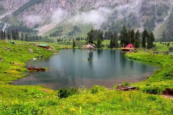 Lake with a pink-roofed pavilion in the green Astore Valley