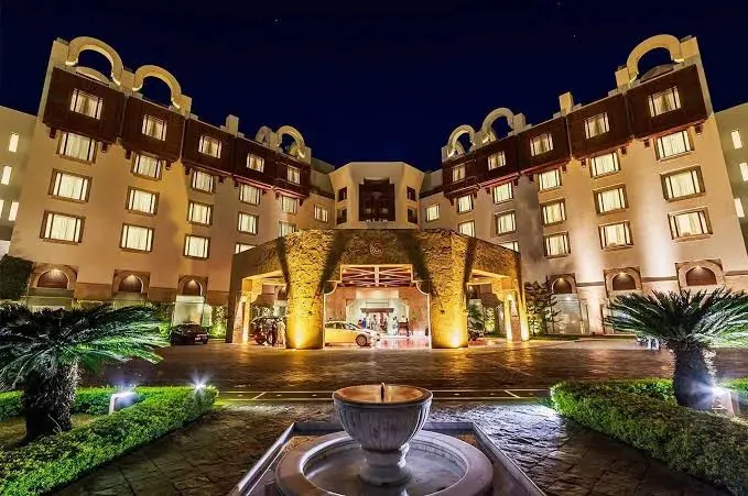 Entrance of Serena Hotel Islamabad lit at night with a fountain in the foreground